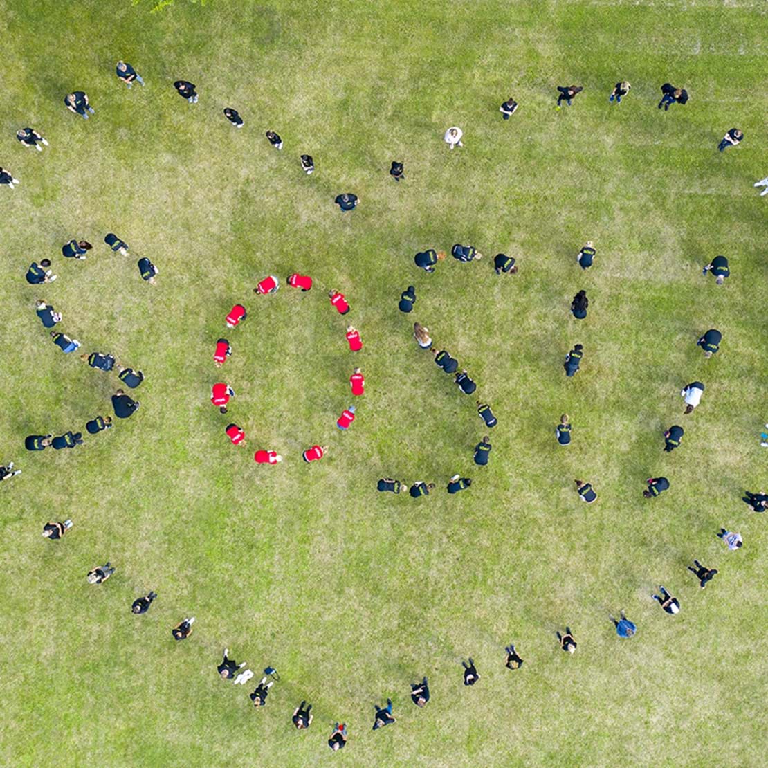 Billede af elever der med deres kroppe danner ordet SOSU med et hjerte omkring